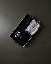 Black travel case with 'STAFF' label on hoodies.